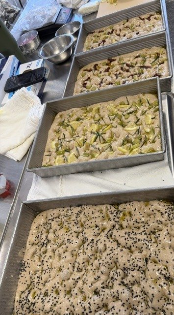 Trays of focaccia out of the oven, ready for a crowd