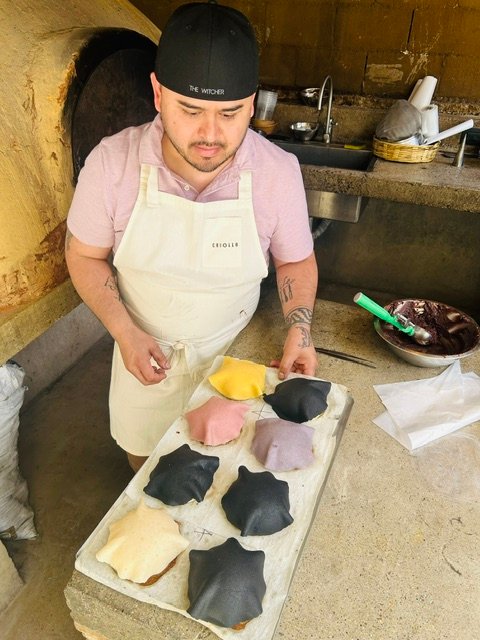 Chef Lupe laying out tortillas by the oven