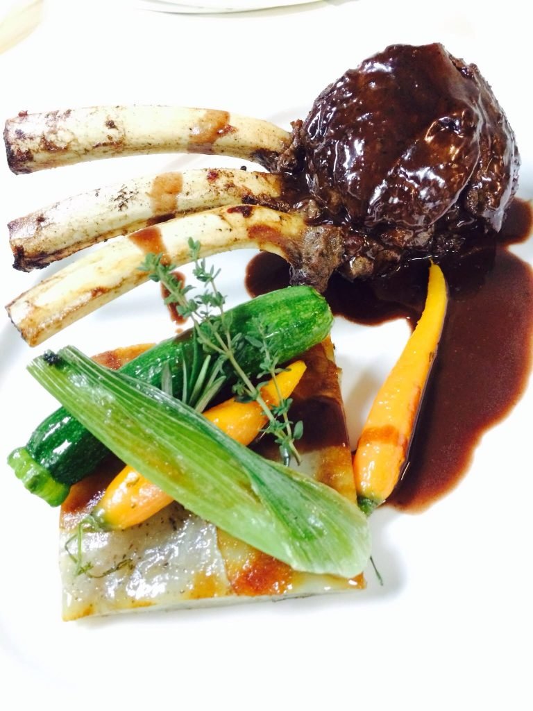 A rack of lamb with glazed root vegetables