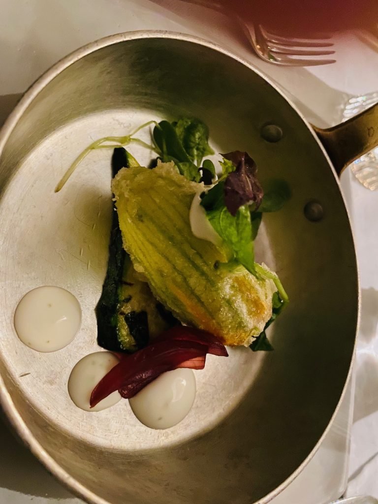 A stuffed squash blossom, plated dark