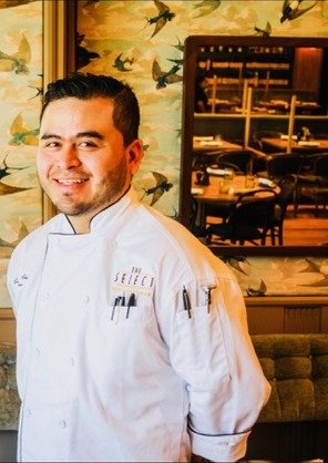 Chef Lupe in the dining room, in whites