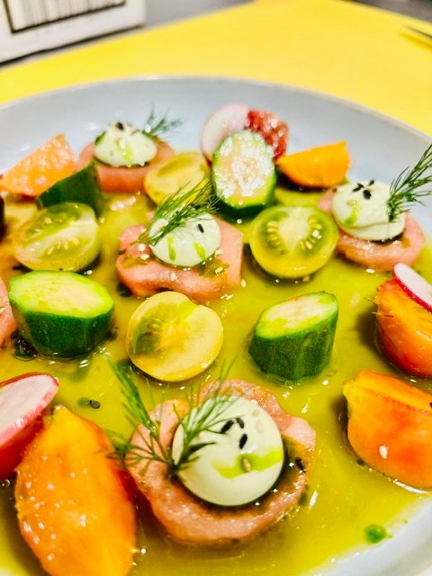 Cured fish, close, with tomato and herb oil