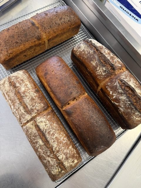 Sourdough loaves cooling on a wire rack
