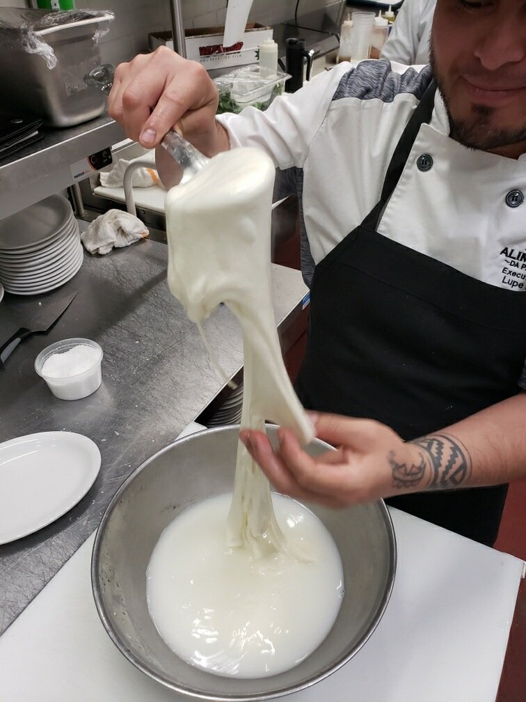 Chef Lupe pulling a fresh ball of mozzarella by hand